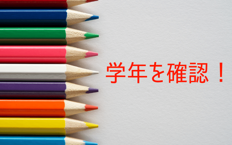 色鉛筆と「学年を確認」の文字