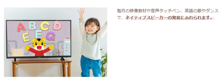 両手を上げる幼児と英語教材画面